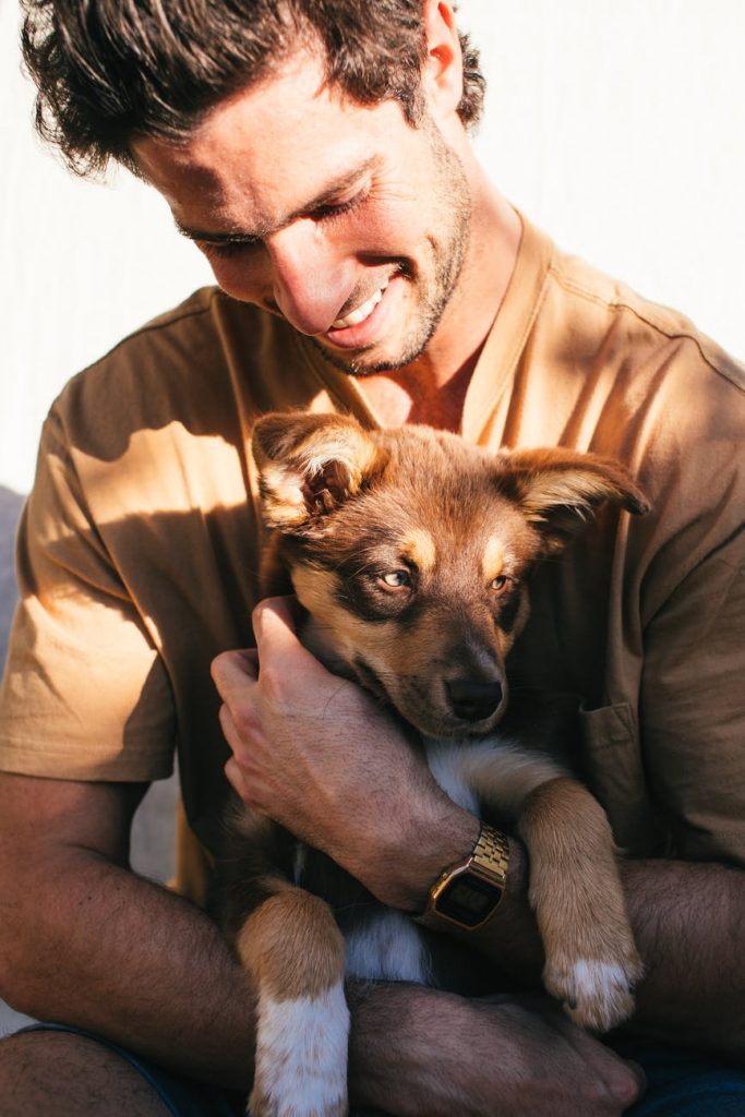 man with puppy in hands